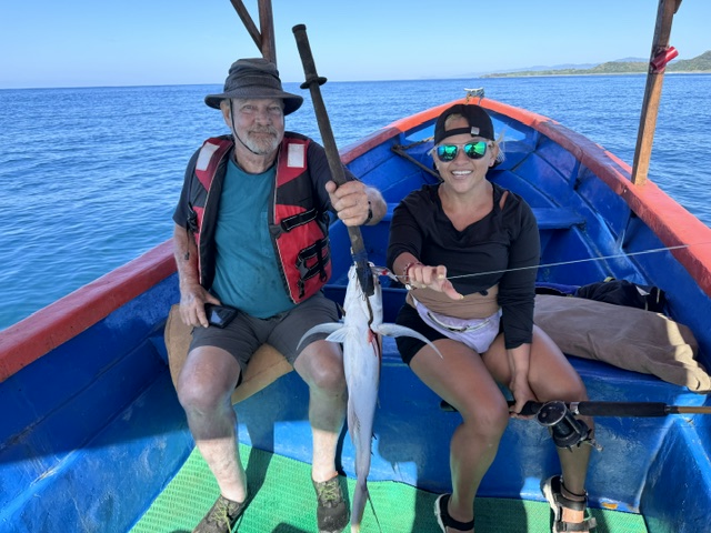 Guest and Scheyla with a fresh catch on the boat