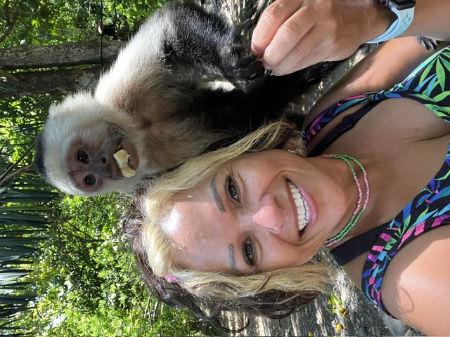 Scheyla with a capuchin monkey on her shoulder